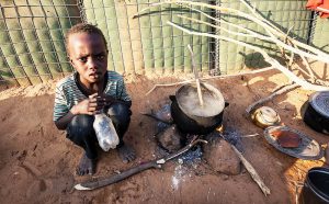 A young boy caught up in the fighting North Darfur, 2015 takes shelter in a refugee camp.