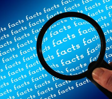 Magnifying glass held over repeated word "facts"