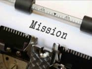 The word "Mission" on a piece of paper in a typewriter