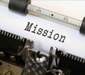 The word "Mission" on a piece of paper in a typewriter